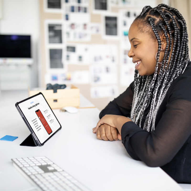 Women sitting at desk watching webinar