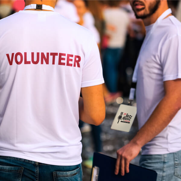 two volunteers working at an event
