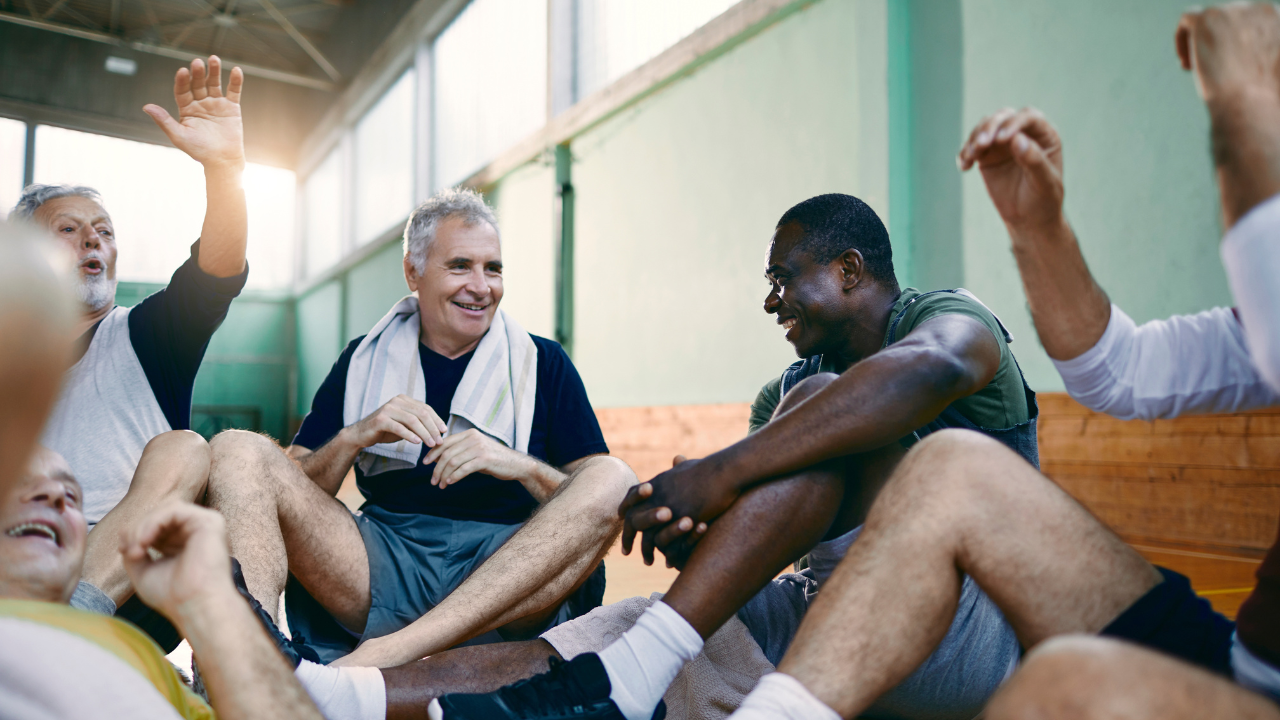 guys sitting in a gym after playing basketball